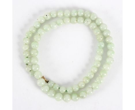 A single row of celadon jade beads, 48.5cm long