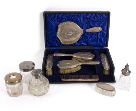 A silver backed dressing table set, Chester circa 1910, comprising hand mirror, pair of hair brushes, pair of clothes brushes