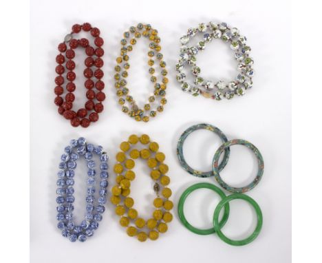 A group of Oriental jewellery to include two jade bangles, two cloisonne bangles, two cloisonne beaded necklaces, two lacquer