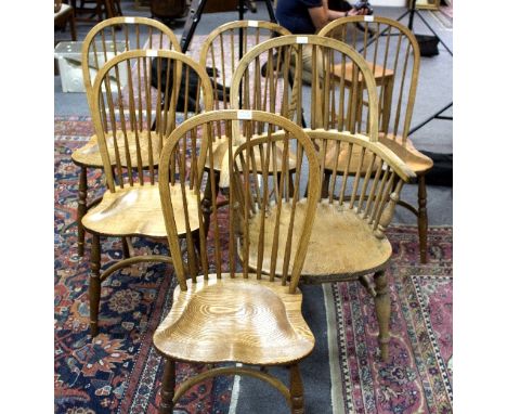 Six stick back chairs with elm seats, five singles and an armchair