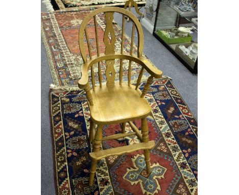 A child's stick and pierced back high chair, on turned legs