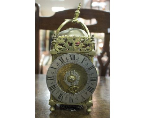 A reproduction lantern clock of usual form, the silvered dial with Roman numerals, signed Nicholas Coxiter, Londini fecit, st