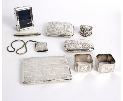 A silver heart-shaped pill box, Birmingham 1894, 4cm wide, three cigarette cases, a vesta case, two napkin rings etc. approxi