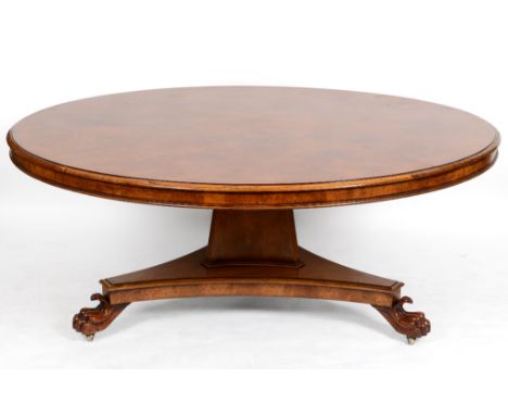 An early 19th century style centre table, inlaid in pollard oak, on a triangular column and concave sided platform base with 