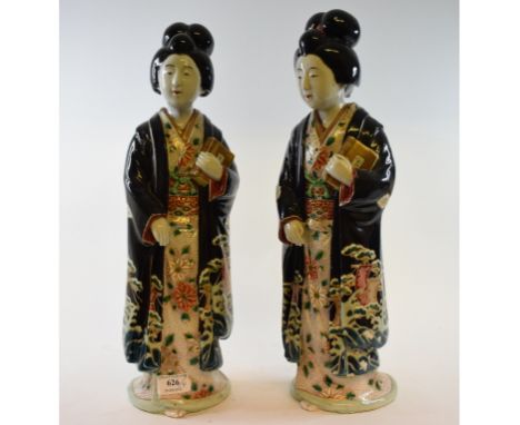 A pair of Japanese geisha figures, each holding books, 44 cm high (2) Condition report Report by GH

Some losses to the black