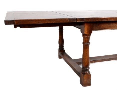 An 18th century style oak draw leaf dining table, on baluster turned legs, 308 cm wide  See illustration Condition report Rep