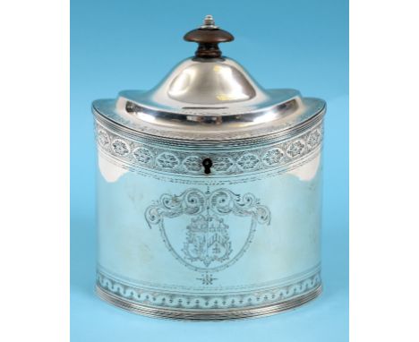 A late 18th century silver tea caddy, of navette form, decorated an armorial and engraved decoration, with a turned wood fini