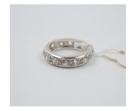 A white coloured metal and diamond eternity ring, approx. ring size K