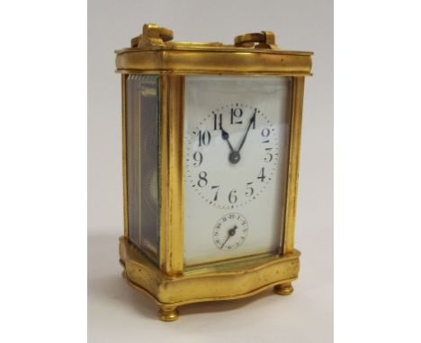 A carriage clock, with a 5.5 cm wide enamel dial, in a shaped brass case, striking on a bell, 15.5 cm high Condition report R