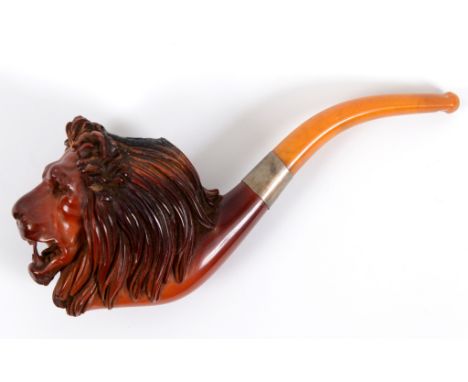 A 19th century Meerschaum pipe, the carved bowl in the form of a lion's head, with an amber stem, cased, 19 cm long, and five