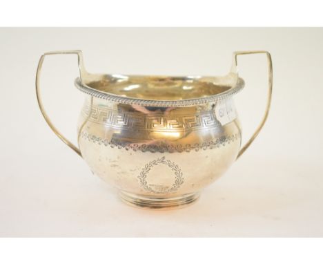 A George III silver two handled bowl, with engraved Greek Key pattern and foliate decoration, crested, Robert Hennell I & Sam