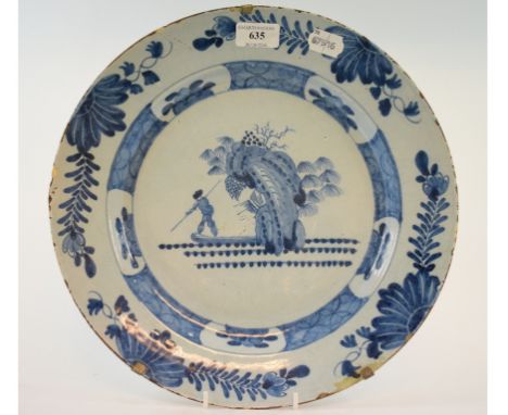 A Dutch Delft plate, decorated a figure hunting in a boat, 34 cm wide