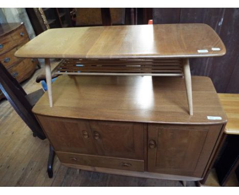 An Ercol elm sideboard, 114 cm wide, a pair of Ercol carver chairs, with a matching pair of single chairs, an Ercol coffee ta