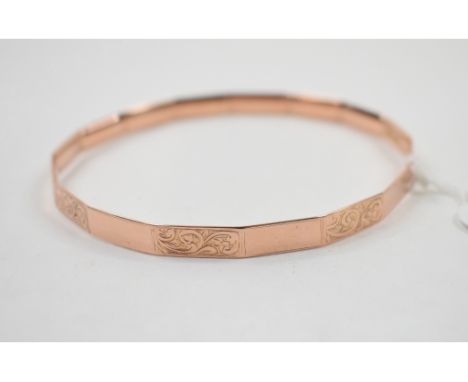 A 9ct gold bangle, with engraved decoration, approx. 17.6 g