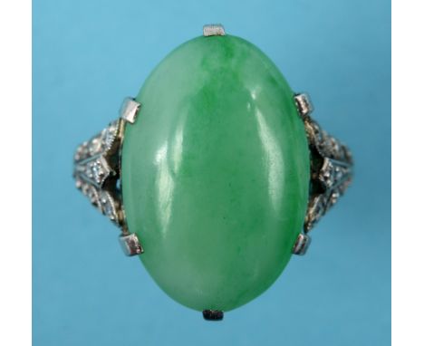 A platinum and oval jade cabochon ring, with diamond set shoulders, approx. ring size L½  See inside back cover colour illust