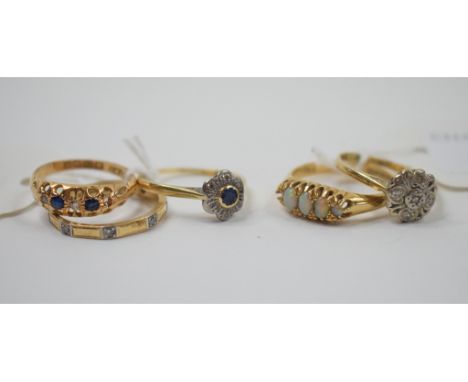 An 18ct gold and opal ring (lacks one stone), and four other rings (5) Condition report Report by MW

Yes, there are diamonds