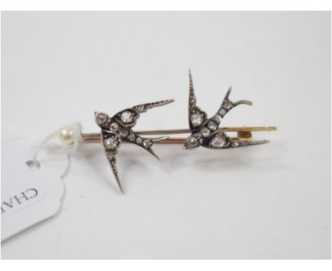A Victorian bar brooch, applied two swallows set diamonds chasing a pearl, inscribed and dated 1885 Condition report Report b