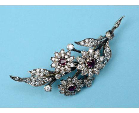 A diamond floral spray brooch, each flowerhead with a central ruby, fitted in a Hunt & Roskell Late Storr & Mortimer London b