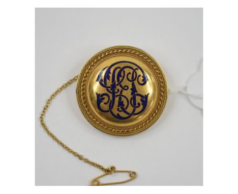 A Victorian gold coloured metal brooch, of circular form, with an enamel monogram, gift inscription verso, approx. 14.2 g