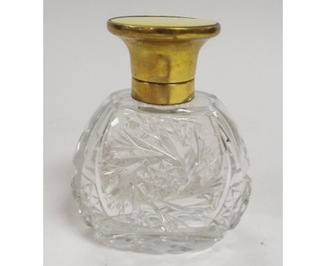 A glass scent bottle, the top with enamel decoration, 10.5 cm high