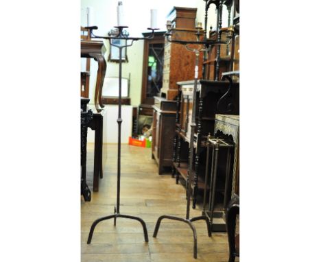 A pair of Arts and Crafts style wrought iron three light floor standing lamps, adapted to electricity (2)