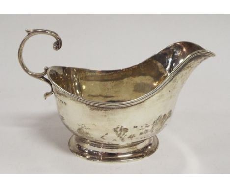 A silver sauce boat, Sheffield 1919, another, two silver toast racks, a silver backed clothes brush, and a silver powder comp