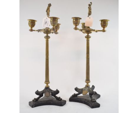 A pair of brass classical style three light candelabra, with figural finials, 44 cm high