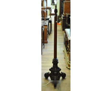 A mahogany standard lamp, on a richly carved base