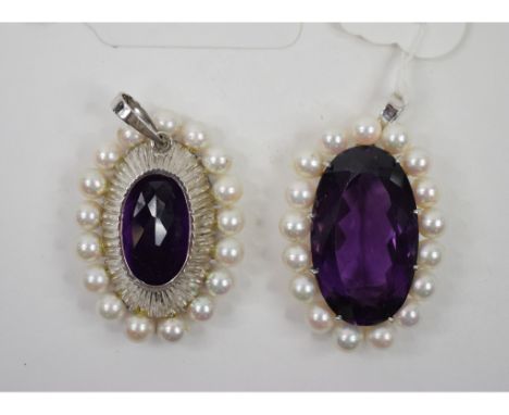 A near pair of white coloured metal oval pendants, each set a large amethyst within a surround of pearls (2)