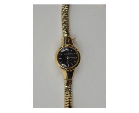 A lady's 9ct gold Jaeger LeCoultre wristwatch, having a black dial Condition report Report by GH

Face a little tarnished and
