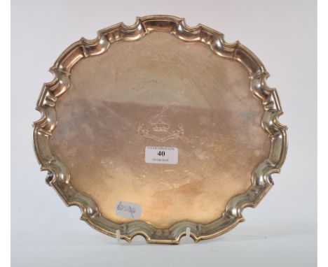 An 18th century style silver salver, crested beneath a motto, the reverse inscribed 'A gift to the Rev C R Deakin...1909-1923