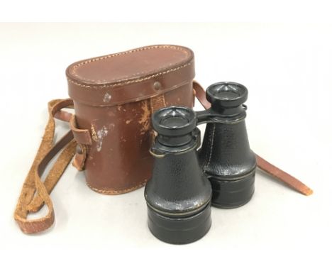 A pair of vintage leather cased field glasses