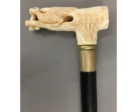 A bone handled walking stick, the top formed as a bird. 93 cm long.