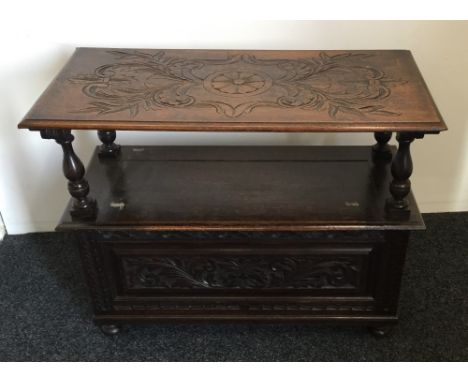 A carved oak monks bench