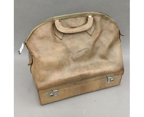 A vintage leather Gladstone bag