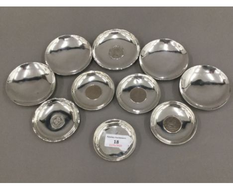 A quantity of small Chinese sterling silver coin set dishes and other unmarked small dishes (14 .2 troy ounces total weight)