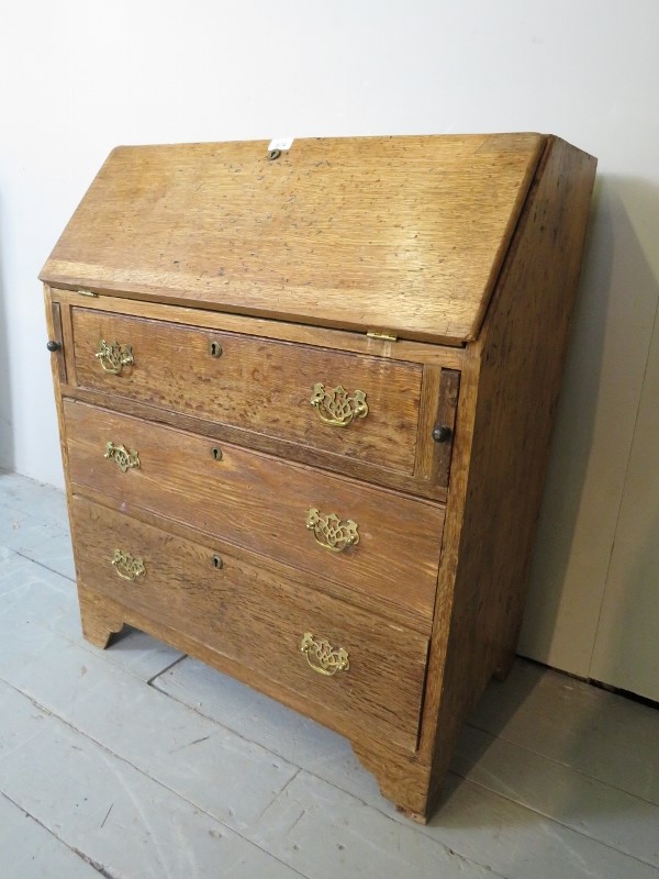 A 19c light oak and pine bureau with fitted interior over three long