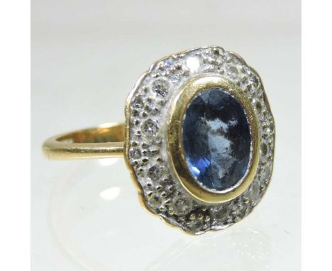 An 18 carat gold sapphire and diamond cluster ring, of oval shape, 4.2g, size N/O, boxed15 x 13mm diameter