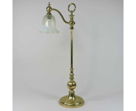 An early 20th century Arts and Crafts brass adjustable table lamp, in the manner of W A S Benson, with a vaseline glass frill