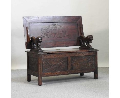 An early 20th century carved oak monk's bench, with a rising seat and hinged back104w x 48d x 100h cm overall