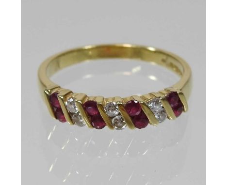 An 18 carat gold, ruby and diamond half-hoop eternity ring, 3.3g, size P