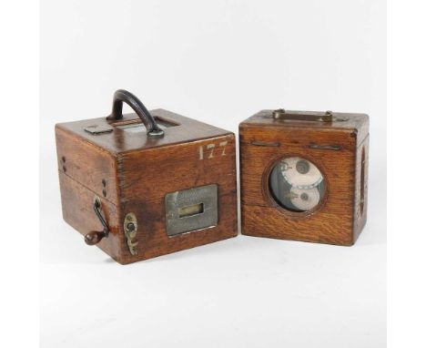 An early 20th century continental oak cased pigeon racing clock, together with another smaller24w and 18w cm