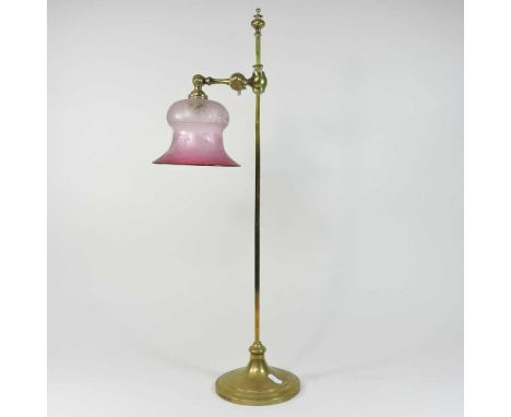 An early 20th century brass table lamp, with a bell shaped etched coloured glass shade62cm highCondition report: The shade ha