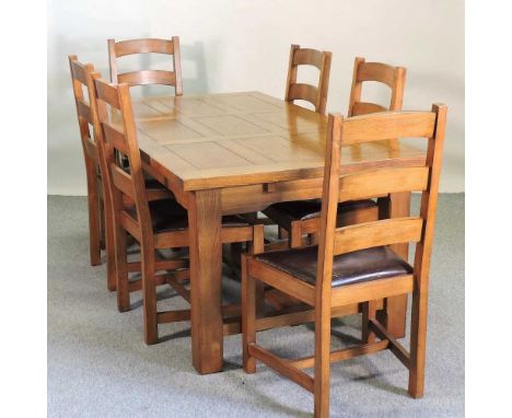 A modern oak dining table, together with a set of six ladder back dining chairs, with padded seats180w x 100d x 77h cm
