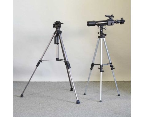 A Bushnell telescope, on an adjustable tripod stand, together with another tripod