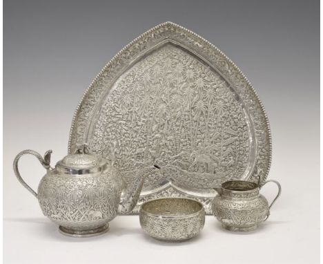 Indian white metal four piece tea service comprising: globular teapot, the hinged cover with elephant finial, hooded cobra ha