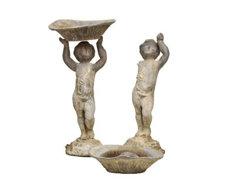 Pair of antique lead figural garden planters, in the manner of John Cheere, each modelled as a young boy holding a basket abo