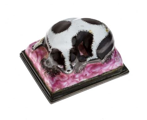 Late 18th Century Staffordshire enamel bonbonniere modelled as a black and white spaniel lying on a pink mottled cushion, the