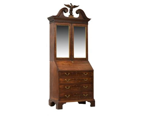 George III Irish mahogany bureau cabinet, the upper stage having a finely-carved swan neck pediment with dentil moulding, flo