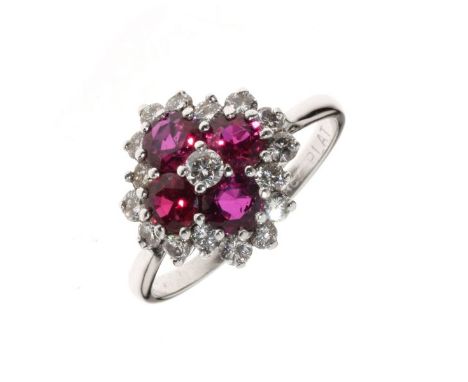 Diamond and ruby cluster ring, stamped '18ct' and 'Plat', the four round cut rubies enclosing a central diamond, all enclosed